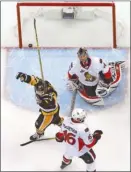  ?? The Associated Press ?? Pittsburgh Penguins forward Carter Rowney celebrates a goal by Bryan Rust as Ottawa Senators goalie Craig Anderson looks on during the first period of Game 5 of the Eastern Conference final in Pittsburgh on Sunday. The Penguins won 7-0.