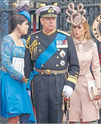  ??  ?? Prince Andrew with daughters Eugenie, left, and Beatrice at the wedding of Prince William and Kate in Westminste­r Abbey in 2011