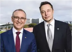  ?? —AFP ?? ADELAIDE: South Australia’s Premier Jay Weatherill (left) and Tesla Motors CEO Elon Musk are pictured in this photo in Adelaide. Elon Musk’s Tesla said it will build what the maverick entreprene­ur claims is the world’s largest lithium ion battery...