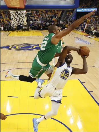  ?? AP ?? Golden State’s Draymond Green is defended by Al Horford during the first half of Game 2 of the NBA Finals in San Francisco on Sunday.