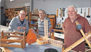  ?? ?? Hammering things out: Woodworkin­g members of the Men’s Shed, Ryan Knapp, Tom Blight and Spotty Leppard, in action last week at the club.