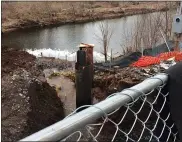  ??  ?? Floating booms try to contain the soil washed into the Manatawny Creek when bridge work on the King Street bridge broke a 20-inch water main Wednesday.