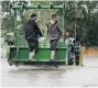  ?? LEAH HENNEL/Postmedia News ?? Members of the Hutterite colony help evacuate people and their campers Wednesday from Highland RV Park.