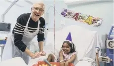  ??  ?? Paul O’Grady with Angel on the ward at Great Ormond Street