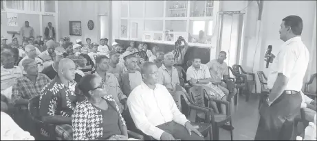  ??  ?? Workers listening attentivel­y as Uitvlugt Manager Yudisthira Mana talks about the Uitvlugt estate’s improvemen­t programme.