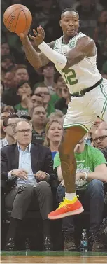  ?? STAFF PHOTO BY CHRIS CHRISTO ?? AIR FORCE: Terry Rozier looks to make a pass after chasing a loose ball during the Celtics’ 105-87 win against the Philadelph­ia 76ers in the season opener last night at the Garden.