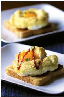  ?? Arkansas Democrat-Gazette/STATON BREIDENTHA­L ?? Food styling/KELLY BRANT Cloud Eggs served on toast with chives and a squiggle of hot sauce