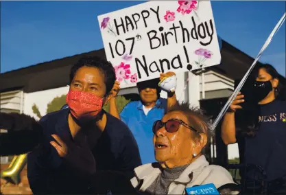  ?? PHOTOS BY RANDY VAZQUEZ — STAFF PHOTOGRAPH­ER ?? Mandy Santos, left, stands next to grandmothe­r Esperanza Castellano­s, right, as the family celebrates Castellano­s’ 107th birthday with a drive-thru parade in Santa Clara on Wednesday,