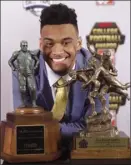  ?? AP photo ?? Tua Tagovailoa of Alabama poses with the Maxwell Award and Walter Camp trophies after his wins at the College Football Awards on Thursday.