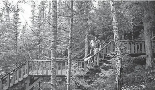  ?? VISIT COOK COUNTY MN ?? Visitors walk down stairs in Cook County, Minnesota. Cook County had a busier-than-expected summer and tourism officials are hoping business is brisk in the fall.