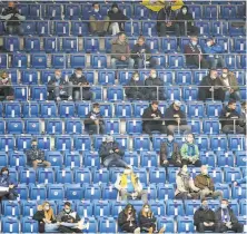  ?? Daniel Roland / AFP via Getty Images ?? Fans spaced out at Saturday’s Bundesliga match between TSG Hoffenheim and Borussia Dortmund in Sinsheim. Soccer may be put on hold again as Germany struggles with the virus.