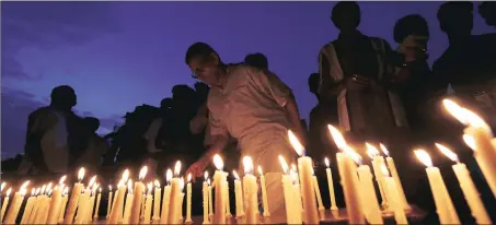  ??  ?? A man lights a candle in Ahmedabad during a vigil for soldiers killed in a terrorist attack on an Indian army base camp in Uri, Jammu &amp; Kashmir