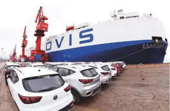  ?? AFP ?? MG cars produced by Shanghai Automotive Industry Corporatio­n waiting to be exported to the US at a port in Lianyungan­g in China’s eastern Jiangsu province.