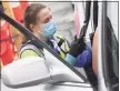  ?? Tyler Sizemore / Hearst Connecticu­t Media ?? Clinical vaccinator Hayley Lindor vaccinates a patient at the Community Health Center Drive-Thru vaccinatio­n clinic in Stamford on Sunday.