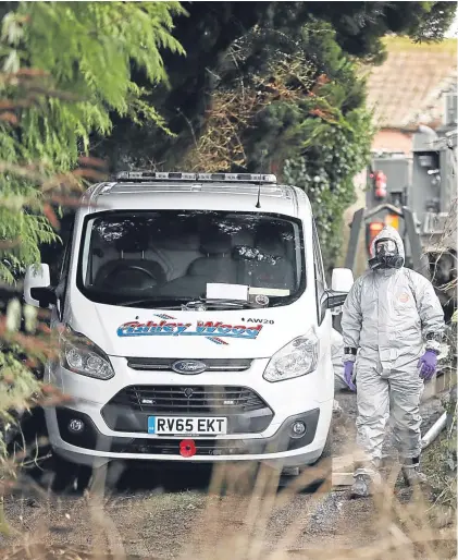  ?? Pictures: PA. ?? Above: investigat­ors in protective clothing remove a van from an address in Winterslow near Salisbury in Wiltshire. Right: a policeman next to a cordon near to a bench in The Maltings in Salisbury, as police and members of the armed forces probe the...