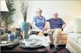  ?? T.J. KIRKPATRIC­K / THE NEW YORK TIMES ?? Tena and Ray Bluhm sit in their new home in the Westminste­r retirement community in Lake Ridge, Va. The Bluhms needed to downsize before moving into their new home in early August.