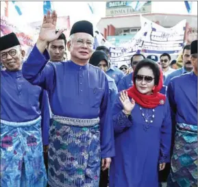  ?? MOHD RASFAN/AFP ?? Malaysia’s then-Prime Minister Najib Razak and his wife Rosmah Mansor arrive at the nomination centre to hand over election documents in Pekan on April 28.