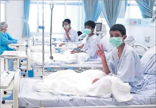  ??  ?? Video message shows young footballer­s rescued from flooded caves relaxing in their hospital beds in Chiang Rai, Thailand