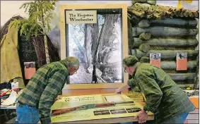  ?? NATIONAL PARK SERVICE VIA AP ?? Workers for the design company DiVittorio and Associatio­ns help install the new exhibit at the visitor center at Great Basin National Park in Baker, Nev., for the “Forgotten Winchester,” an 1882 rifle that was discovered leaning against a tree in 2014.