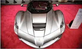  ?? PHOTO: BLOOMBERG ?? A Ferrari LaFerrari Aperta vehicle parked in front of the New York Stock Exchange. Sergio Marchionne confirmed that Ferrari NV has been testing a petrol-electric hybrid car.