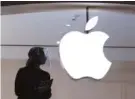  ?? AP PHOTO/MARK LENNIHAN ?? An Apple store employee is shown in New York in February.