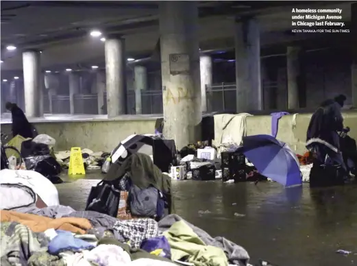  ?? KEVIN TANAKA/FOR THE SUN-TIMES ?? A homeless community under Michigan Avenue in Chicago last February.