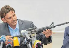  ?? FOTO: DPA ?? Ein Sturmgeweh­r als Tatwaffe: Andreas Stenger vom Landeskrim­inalamt zeigt ein baugleiche­s Modell.