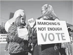  ?? KAMIL KRZACZYNSK­I/AFP/GETTY IMAGES ?? Women gather for a rally and march at Chicago’s Grant Park on Saturday to inspire voter turnout ahead of the midterms.