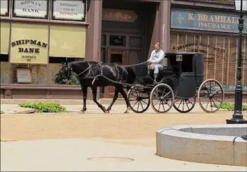  ?? C.J. Lais Jr. / Times Union ?? A carriage driver and his horse seem to have Monument Square in Troy to themselves on Tuesday between shooting scenes for the HBO series “The Gilded Age.“