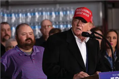  ?? PHOTO BY REBECCA DROKE/AFP VIA GETTY IMAGES ?? East Palestine Mayor Trent Conaway (left) listens to former U.S. President Donald Trump speak at the East Palestine Fire Department in East Palestine, Ohio, on February 22, 2023.