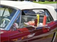  ??  ?? Harold Snavely Jr.’s 1964 1⁄2 Ford Mustang Convertibl­e looks like it made a stop at a drive-in eatery.