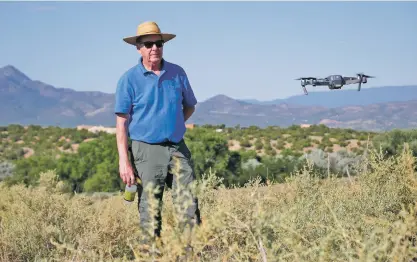  ?? MATT DAHLSEID/THE NEW MEXICAN ?? ‘I love it,’ Michel says of the drone footage. ‘Fantastic. We’ve done aerial photos of this location but nothing like this. Just amazing.’