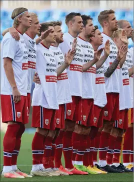  ?? ?? Norway’s players wearing T-shirts that read ‘Fair play for migrant wokrers’