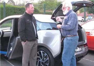  ??  ?? Bruce Stell from Valley BMW (left) discusses the BMW i3 with Darold Klindworth during an electric vehicle briefing in Warragul presented by Baw Baw Sustainabi­lity Network.