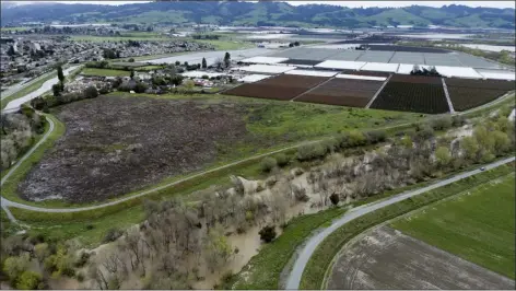  ?? PHOTOS BY CALIFORNIA STRAWBERRY COMMISSION VIA AP ?? This photo provided by the California Strawberry Commission shows a flooded Pajaro River area in Pajaro, Calif. on Tuesday. California’s strawberry farms have been hit hard by this year’s winter storms. Industry experts estimate about a fifth of strawberry farms in the Watsonvill­e and Salinas areas have been flooded since a levee ruptured last week and another river overflowed.