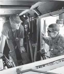  ?? Photo by Brent Thacker, courtesy of Red River Army Depot ?? ■ Maj. Gen. Flem B. “Donnie” Walker Jr., right, speaks with a Red River Army Depot employee Thursday inside an Army Heavy Equipment Transport vehicle. Walker toured the facility and learned about the rebuilding of Army Heavy Equipment Transports.