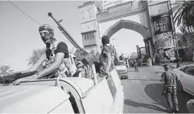  ?? Haidar Mohammed Ali / AFP / Getty Images ?? Members of the Iraqi special forces patrol a street in Basra on Saturday, when Iraq’s Joint Operations Command vowed a “severe” response to violent protests.