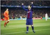  ?? THE ASSOCIATED PRESS ?? Barcelona’s Lionel Messi celebrates after scoring his side’s third goal as Chelsea goalkeeper Thibaut Courtois, left, stands defeated during the Champions League round of sixteen match between FC Barcelona and Chelsea. The Associated Press