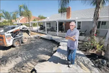  ??  ?? DAVID HARMS is replacing the pool in his Yorba Linda backyard with artificial turf and pavers. Well-maintained pools and their surroundin­g hardscapes use about the same amount of water as a lawn of the same size.