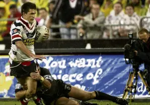  ?? PHOTO: GETTY IMAGES ?? The tackle . . . Sattler shuts down Roosters winger Todd Byrne during the 2003 NRL grand final.