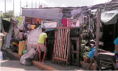  ?? —NORMANMEND­OZAANDLITO TECSON ?? Police kicked their way into this shanty where the Umpad family lived in the CICC grounds and shot dead drug suspects and brothers Jerome, John Vincent and Ruben who are now being mourned at a wake (top photo) near their rundown house.