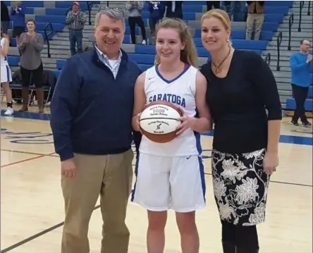  ?? STAN HUDY SHUDY@DIGITALFIR­STMEDIA.COM @STANHUDY ON TWITTER ?? Saratoga Springs senior Kerry Flaherty stands at center court with her Coach Robin Chudy and athletic director Peter Sheehan, honored immediatel­y after scoring her 1,000th career point Tuesday night.