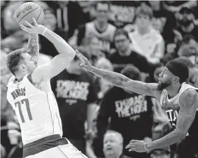  ?? Rick Bowmer / Associated Press ?? Mavericks guard Luka Doncic, shooting over the Jazz’s Royce O’neale in Game 6 in the first round, missed the first three games with a calf strain.