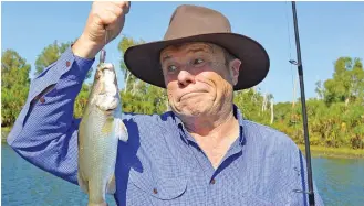  ??  ?? Charles Wooley catches a smaller-than-expected barramundi during a trip to the Northern Territory, where he spent a week with the fun-loving crew of the popular NT News for an upcoming 60 Minutes story.