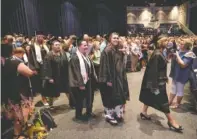  ??  ?? Graduates walk in the procession­al during Chattanoog­a State’s commenceme­nt ceremony at Abba’s House.
