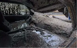  ?? AFP ?? Mud fills the interior of a car destroyed in a rain-driven mudslide in a neighbourh­ood under mandatory evacuation in Burbank. —