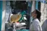  ?? (AFP) ?? A health worker takes a swab sample from a man to be tested for coronaviru­s in Beijing on Saturday.