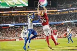  ?? Scott Strazzante/The Chronicle 2021 ?? George Kittle grabs a TD pass against the Rams' Darious Williams at Levi's Stadium on Nov. 15, 2021, a win that launched the 49ers' second-half surge.