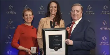  ??  ?? Sandra Borrism of Oulartleig­h Equestrian (centre) receiving All-Ireland Business Foundation All-Star accreditat­ion at Croke Park from Dr Briga Hynes of the Kemmy Business School at the University of Limerick and Minister of State for Trade, Employment and Business, Pat Breen.