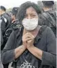  ?? AFP/GETTY IMAGES ?? A woman searches for her missing relatives in San Miguel Los Lotes.